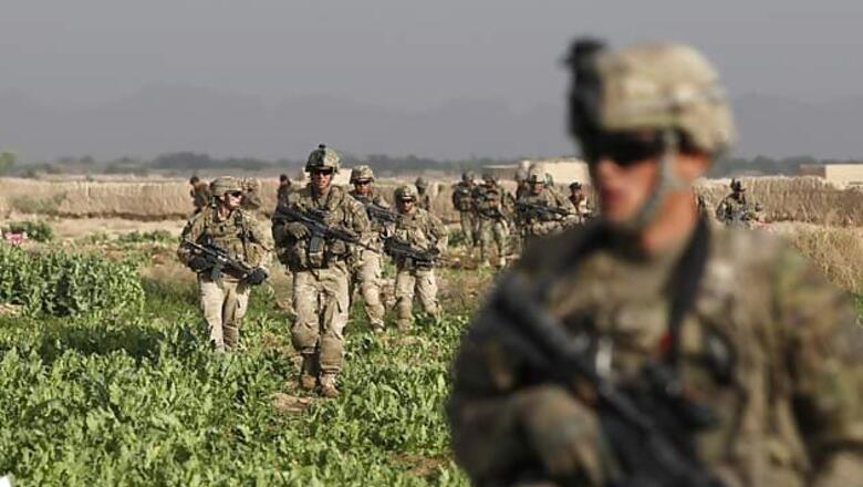 US troops pose with maimed Afghan insurgent bodies