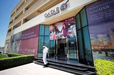 S&P cuts Qatar's credit rating one notch to AA-
