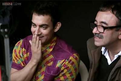 'PK' behind the scenes: Aamir Khan tugs at a barber's dhoti; Rajkumar Hirani asks his assistant director to use a hanger to create a wedgie